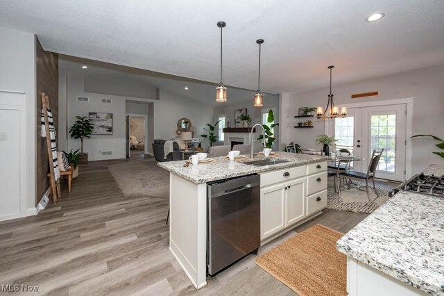 2692 Aspen Dr, Girard, OH 44420 - kitchen featuring dishwasher, white cabinetry, light wood finished floors, vaulted ceiling, and a center island with sink