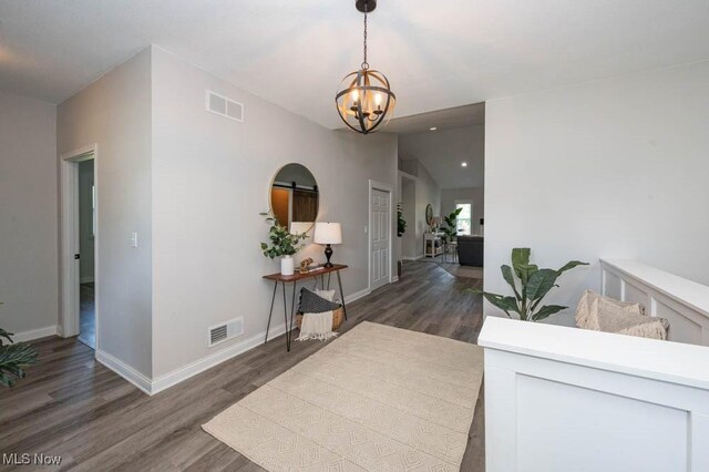2692 Aspen Dr, Girard, OH 44420 - hall featuring lofted ceiling, a chandelier, and wood finished floors