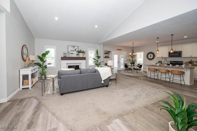 2692 Aspen Dr, Girard, OH 44420 - living room featuring a fireplace, wood finished floors, vaulted ceiling, healthy amount of natural light, and recessed lighting