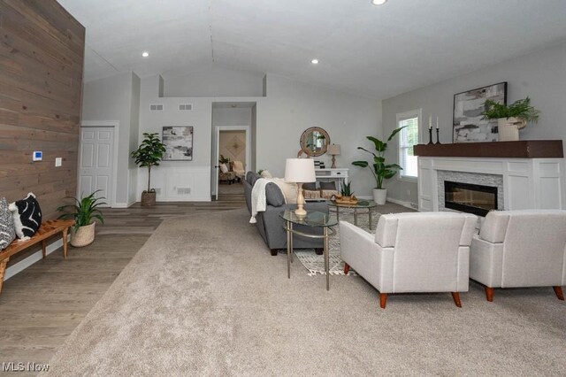 2692 Aspen Dr, Girard, OH 44420 - living room featuring a glass covered fireplace, wood finished floors, vaulted ceiling, and recessed lighting