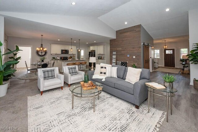 2692 Aspen Dr, Girard, OH 44420 - living area with a barn door, a chandelier, high vaulted ceiling, and recessed lighting