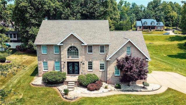 5123 Glenbrook Dr, Vienna, WV 26105 - view of front of house with french doors, a front yard, roof with shingles, and concrete driveway