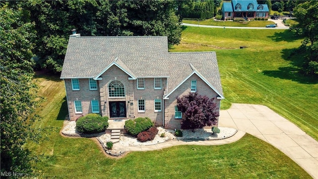 5123 Glenbrook Dr, Vienna, WV 26105 - view of front of home featuring a front lawn, french doors, a chimney, and driveway