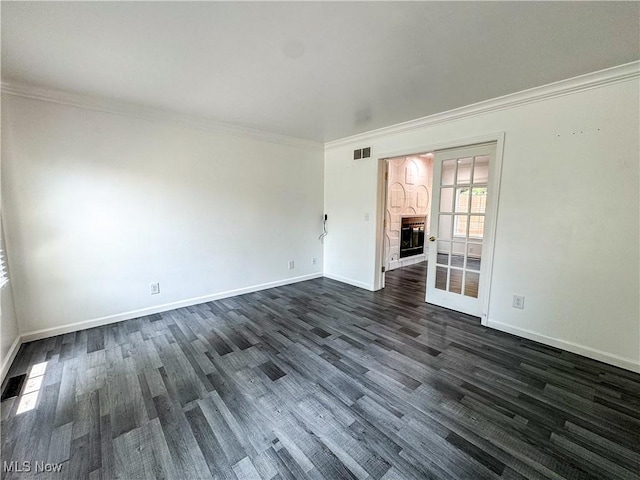 5123 Glenbrook Dr, Vienna, WV 26105 - unfurnished room with dark wood-style floors, a glass covered fireplace, and crown molding