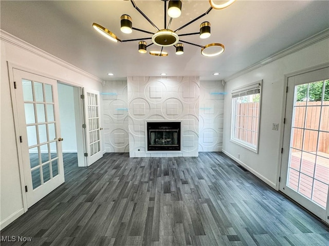 5123 Glenbrook Dr, Vienna, WV 26105 - unfurnished living room with crown molding, a chandelier, wood finished floors, a fireplace, and french doors