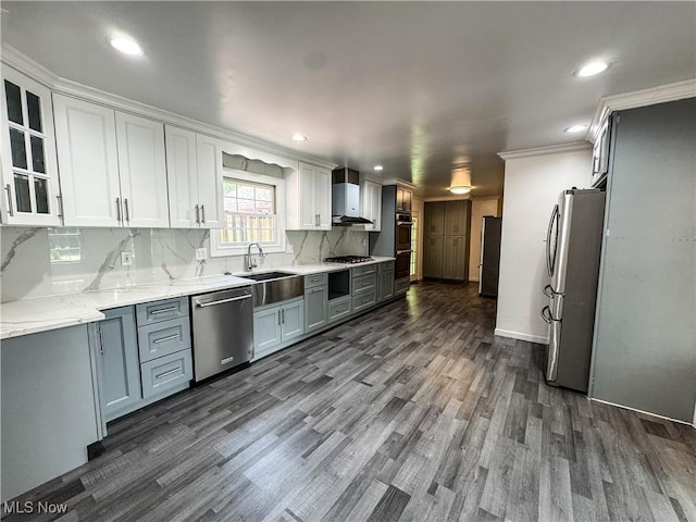 5123 Glenbrook Dr, Vienna, WV 26105 - kitchen with stainless steel appliances, wall chimney exhaust hood, dark wood-type flooring, white cabinets, and ornamental molding
