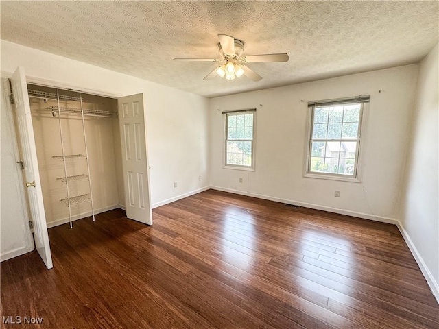 5123 Glenbrook Dr, Vienna, WV 26105 - unfurnished bedroom with dark wood-type flooring, a textured ceiling, a closet, and ceiling fan