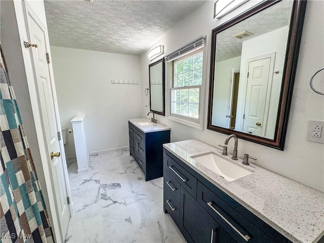 5123 Glenbrook Dr, Vienna, WV 26105 - full bathroom with marble finish floors, two vanities, and a textured ceiling