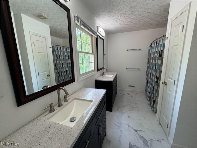 5123 Glenbrook Dr, Vienna, WV 26105 - bathroom featuring marble look tiles, two vanities, a textured ceiling, and curtained shower