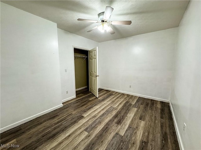 5123 Glenbrook Dr, Vienna, WV 26105 - unfurnished bedroom with dark wood-style flooring, a closet, a ceiling fan, and a textured ceiling