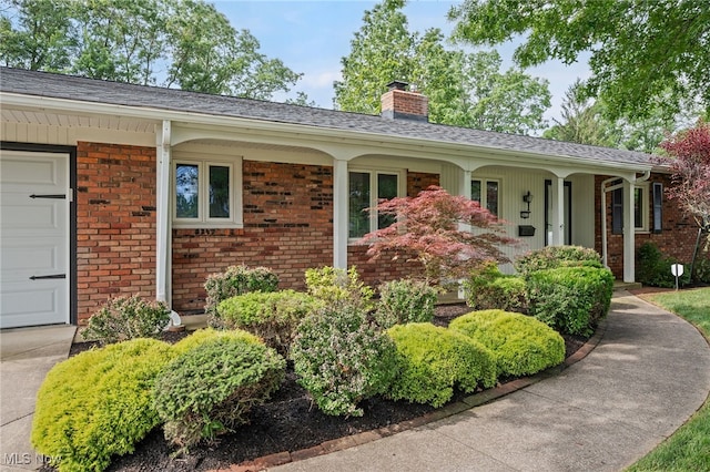 3612 Vezber Dr, Seven Hills, OH 44131 - view of front of home with a chimney, brick siding, and covered porch