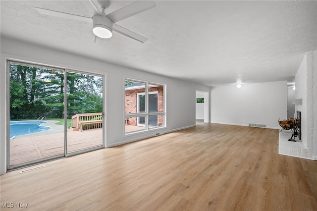 3612 Vezber Dr, Seven Hills, OH 44131 - unfurnished living room with wood finished floors, a textured ceiling, and ceiling fan