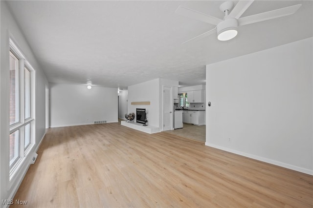 3612 Vezber Dr, Seven Hills, OH 44131 - unfurnished living room featuring a ceiling fan and light wood-style floors