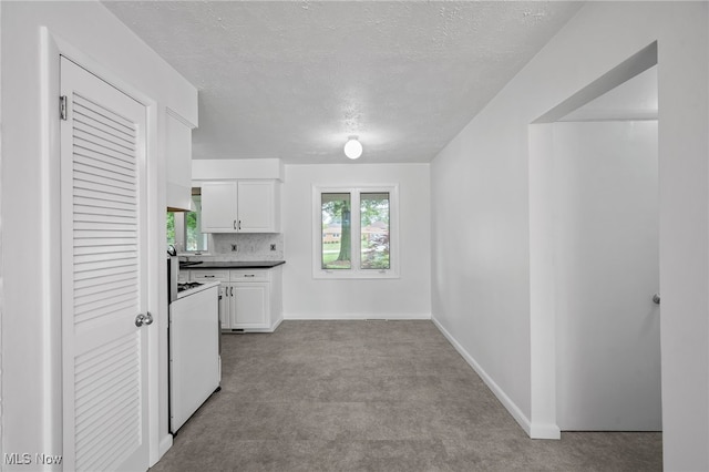 3612 Vezber Dr, Seven Hills, OH 44131 - kitchen with carpet floors, white cabinetry, a textured ceiling, white electric stove, and premium range hood