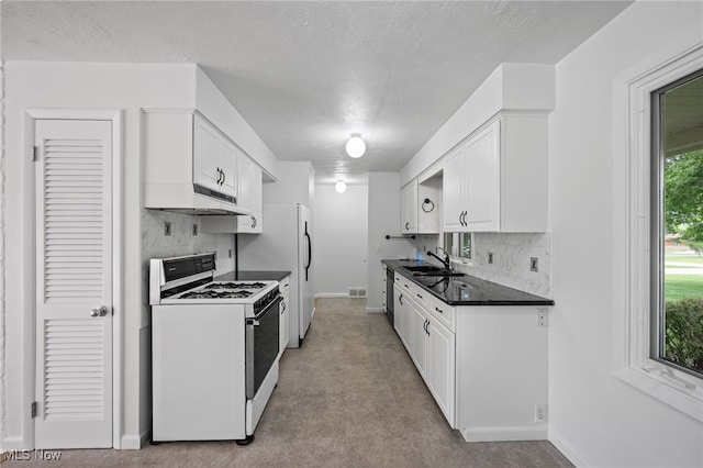 3612 Vezber Dr, Seven Hills, OH 44131 - kitchen with white appliances, under cabinet range hood, backsplash, white cabinetry, and a textured ceiling