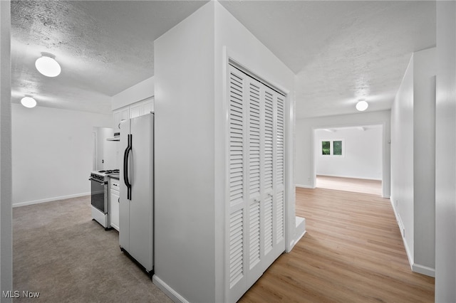 3612 Vezber Dr, Seven Hills, OH 44131 - corridor with a textured ceiling and light wood-style flooring