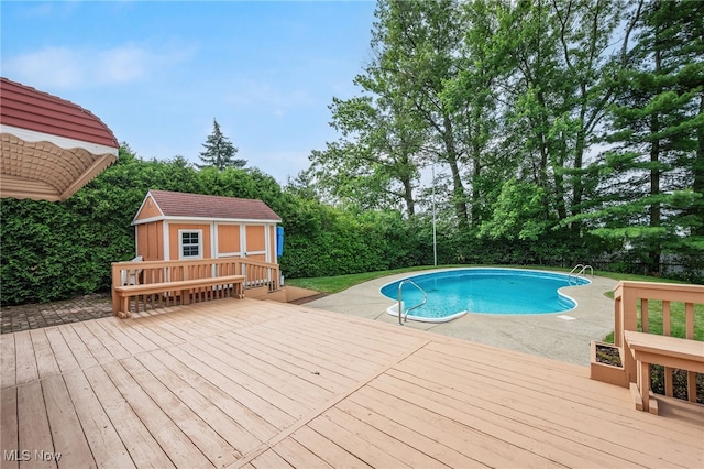 3612 Vezber Dr, Seven Hills, OH 44131 - outdoor pool featuring a deck, an outdoor structure, and view of wooded area