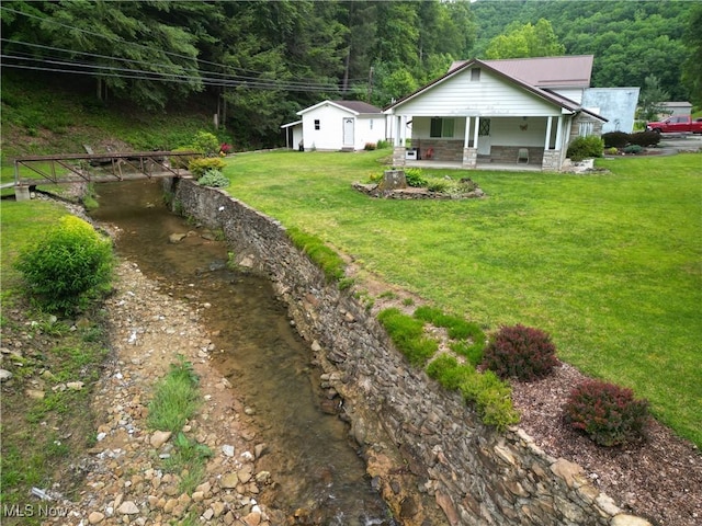 13088 Clay Hwy, Lizemores, WV 25125 - view of grassy yard featuring a porch and a forest view