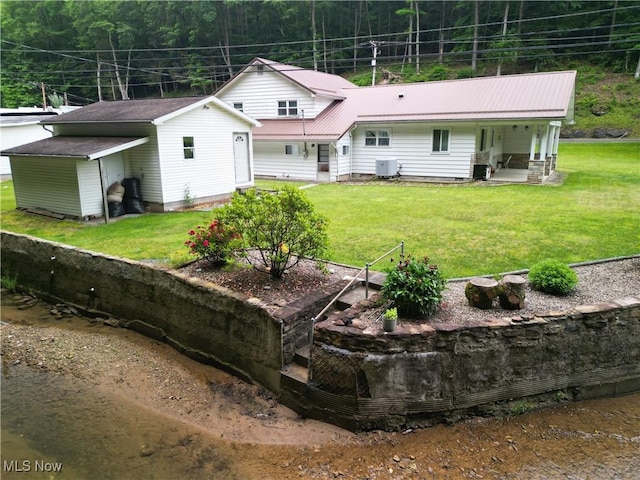 13088 Clay Hwy, Lizemores, WV 25125 - back of house featuring a metal roof, a lawn, a forest view, and covered porch
