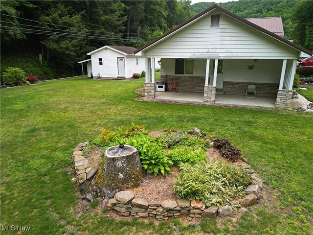 13088 Clay Hwy, Lizemores, WV 25125 - back of property with a yard, stone siding, a porch, and a metal roof