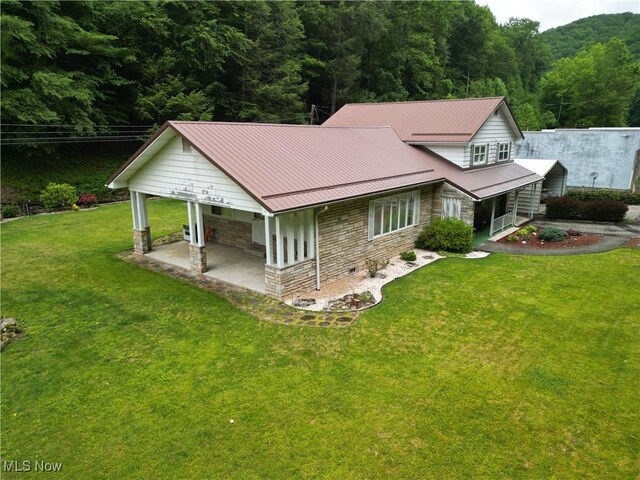 13088 Clay Hwy, Lizemores, WV 25125 - back of property with stone siding, a view of trees, a porch, a yard, and a carport