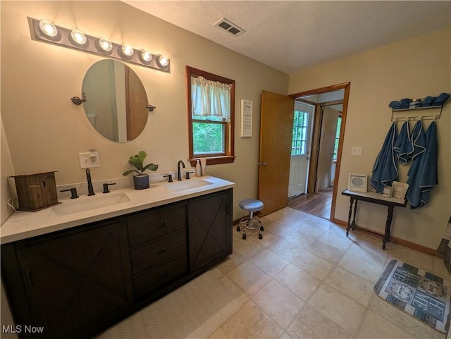 963 Ivydale Rd, Clay, WV 25043 - full bathroom with double vanity and a textured ceiling