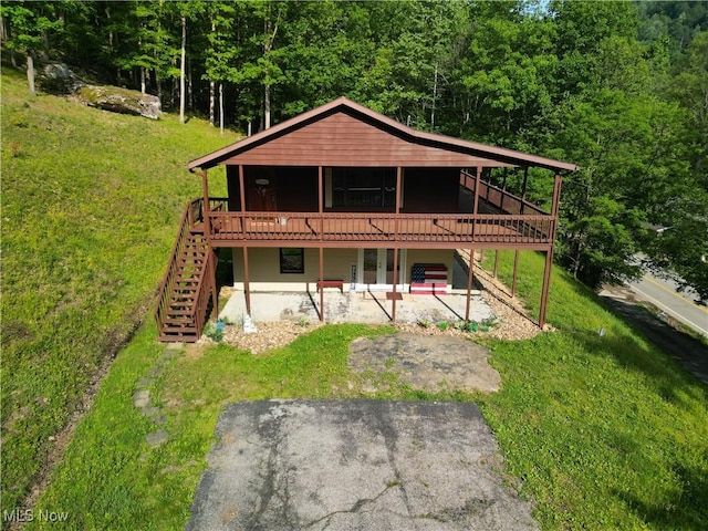 963 Ivydale Rd, Clay, WV 25043 - back of property featuring stairs, a deck, a patio, a lawn, and a forest view