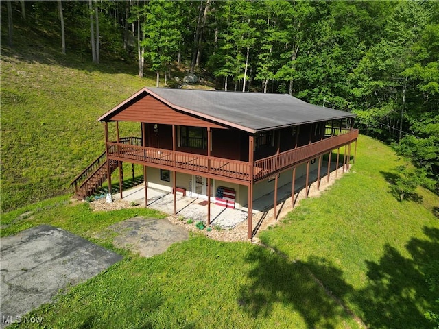 963 Ivydale Rd, Clay, WV 25043 - rear view of house with a wooden deck, a patio area, a yard, a view of trees, and stairway