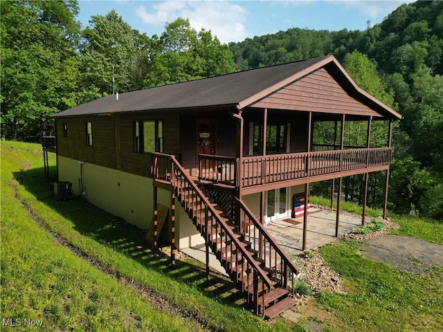 963 Ivydale Rd, Clay, WV 25043 - view of front of property featuring a patio, a deck, a front yard, stairs, and a forest view