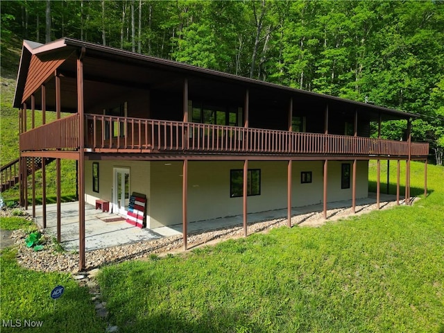 963 Ivydale Rd, Clay, WV 25043 - rear view of house featuring a wooden deck, a patio area, a view of trees, and a yard