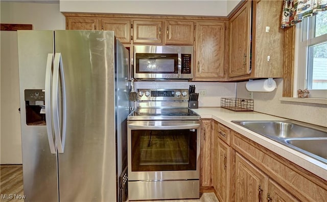816 Vincent Dr, Loudonville, OH 44842 - kitchen with stainless steel appliances, light countertops, and brown cabinetry