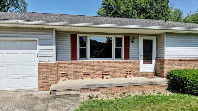 816 Vincent Dr, Loudonville, OH 44842 - view of front of home featuring an attached garage, a shingled roof, and brick siding