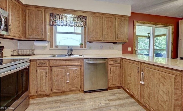 816 Vincent Dr, Loudonville, OH 44842 - kitchen with appliances with stainless steel finishes, healthy amount of natural light, light wood-style floors, and light countertops
