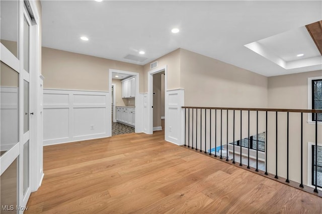 2705 Rocky Ridge Dr, Westlake, OH 44145 - hall with light wood-type flooring, a decorative wall, a wainscoted wall, and recessed lighting