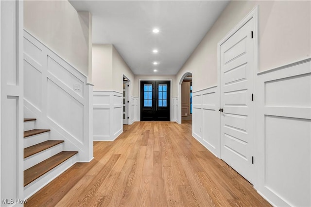 2705 Rocky Ridge Dr, Westlake, OH 44145 - foyer entrance featuring a decorative wall, arched walkways, light wood-style flooring, recessed lighting, and stairway
