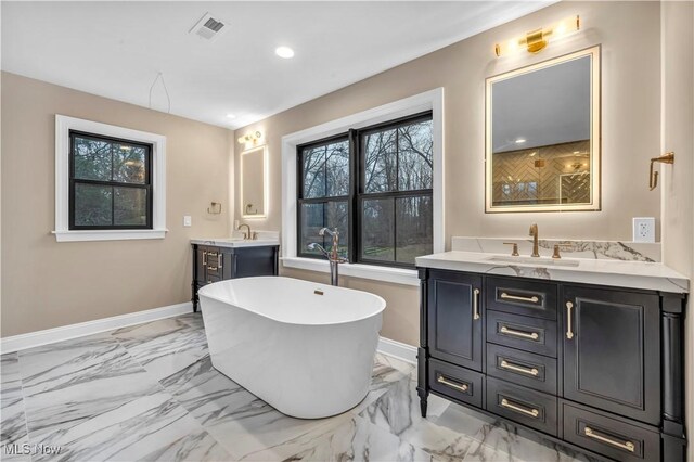 2705 Rocky Ridge Dr, Westlake, OH 44145 - bathroom with vanity, a freestanding bath, marble look tiles, and recessed lighting