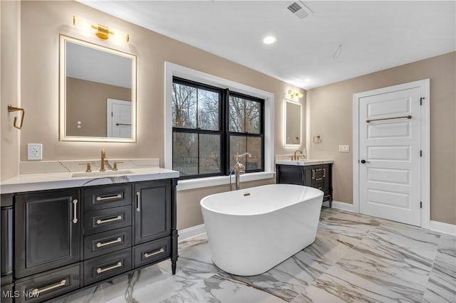 2705 Rocky Ridge Dr, Westlake, OH 44145 - bathroom featuring marble finish floors, vanity, a freestanding bath, and recessed lighting