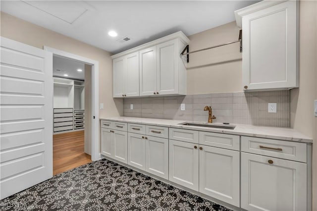 2705 Rocky Ridge Dr, Westlake, OH 44145 - kitchen with white cabinetry, tasteful backsplash, light stone counters, and recessed lighting