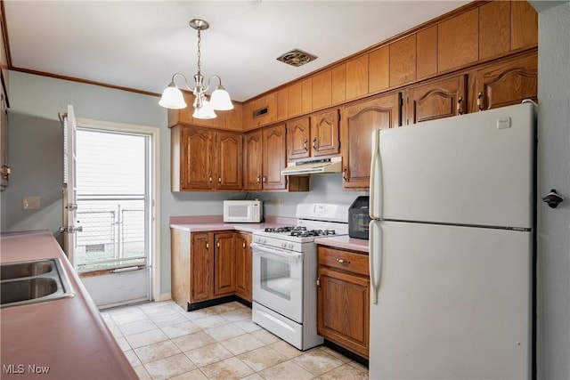 204 W 8 1/2 St, Williamstown, WV 26187 - kitchen with white appliances, under cabinet range hood, brown cabinetry, a chandelier, and light countertops