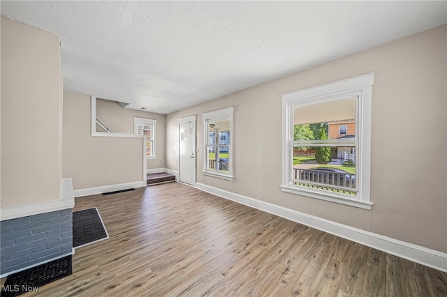 12525 Lancelot Ave, Cleveland, OH 44108 - unfurnished living room with wood finished floors and baseboards