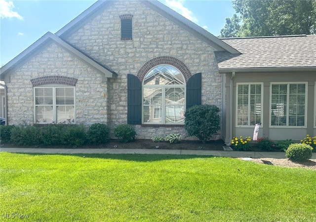 5-118 The Flds, Williamstown, WV 26187 - view of front of property with stone siding, a front yard, and a shingled roof