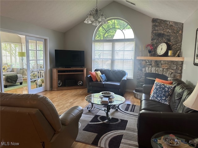 5-118 The Flds, Williamstown, WV 26187 - living area with vaulted ceiling, plenty of natural light, wood finished floors, and a chandelier