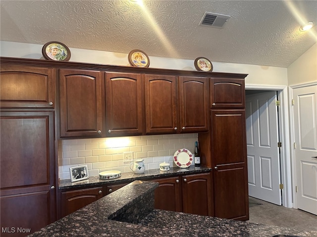 5-118 The Flds, Williamstown, WV 26187 - kitchen featuring dark stone countertops, decorative backsplash, and a textured ceiling