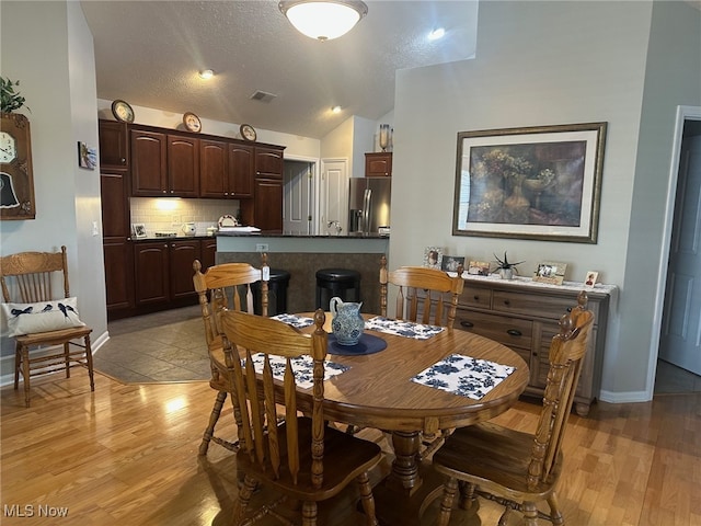 5-118 The Flds, Williamstown, WV 26187 - dining space featuring light wood finished floors, lofted ceiling, and a textured ceiling