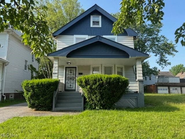 13514 Argus Ave, Cleveland, OH 44110 - view of front of property featuring a front lawn and covered porch