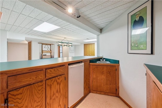 118 Steeplechase Ln, Munroe Falls, OH 44262 - kitchen with brown cabinetry, refrigerator, light carpet, and light countertops