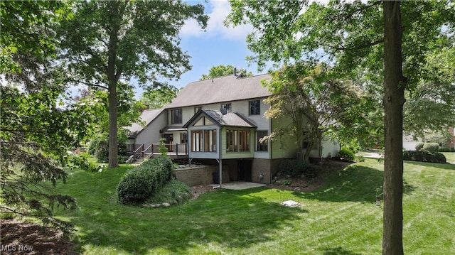 118 Steeplechase Ln, Munroe Falls, OH 44262 - rear view of house featuring a lawn, a wooden deck, and a sunroom