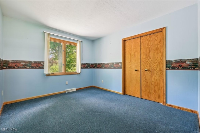 118 Steeplechase Ln, Munroe Falls, OH 44262 - unfurnished bedroom with carpet flooring, a closet, and a textured ceiling