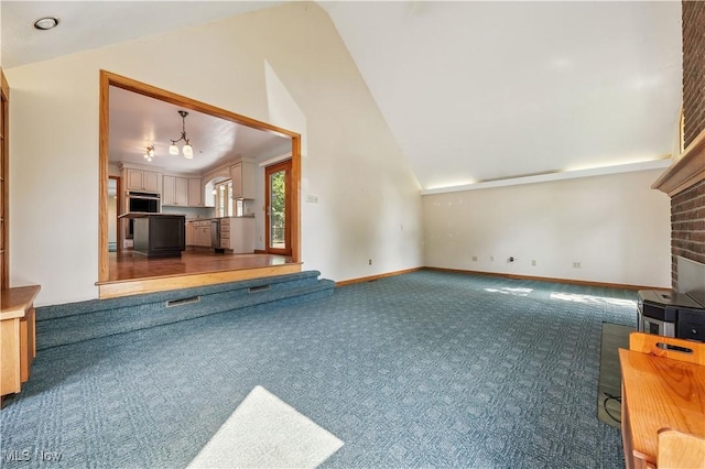 118 Steeplechase Ln, Munroe Falls, OH 44262 - unfurnished living room featuring carpet flooring, vaulted ceiling, and a chandelier