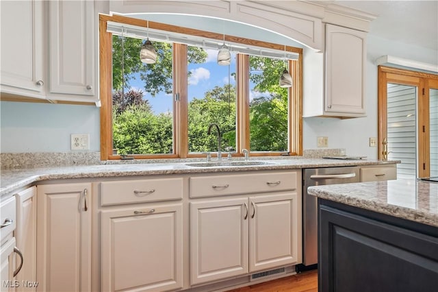 118 Steeplechase Ln, Munroe Falls, OH 44262 - kitchen with white cabinetry, dishwasher, pendant lighting, and light stone countertops
